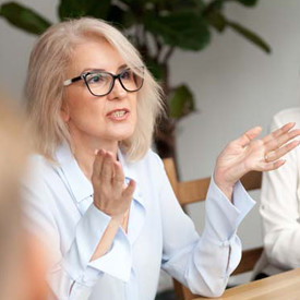 mature woman with glasses in a meeting